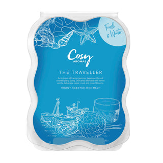 A blue wax melt snap bar with illustrations of flowers and text, labeled 'The Traveller' from Cosy Aromas.